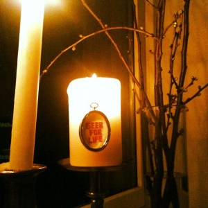 Picture of "geek for life" sign on burning candle